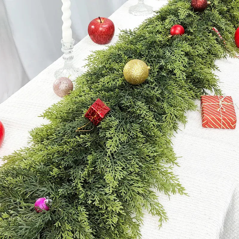 Close-up of cedar-style greenery on a holiday table; decorations not included