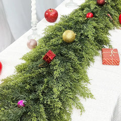 Close-up of cedar-style greenery on a holiday table; decorations not included